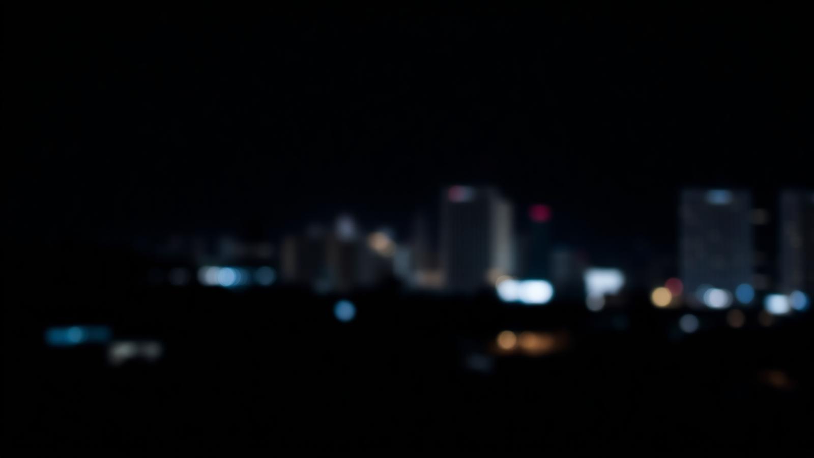 Night lights in midnight blue, evoking the BRAYLAND writing atmosphere